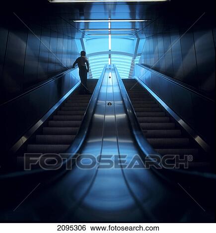 Rear view of man standing on escalator View Large Photo Image Stock Photograph - Rear view of man standing on escalator . Fotosearch