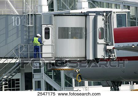 Stock Photography - Rear view of man standing on ramp at airport . Fotosearch