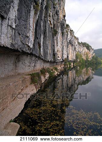 Stock Photo - Reflection of cliff in water . Fotosearch