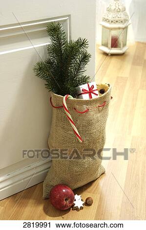 Sack of Christmas tree and presents near door View Large Photo Image Stock Image - Sack of Christmas tree and presents near door . Fotosearch