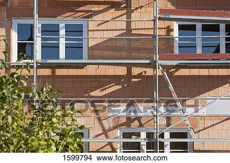 Picture - Scaffoldings on under construction house . Fotosearch