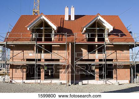 Scaffoldings on under construction house View Large Photo Image Stock Image - Scaffoldings on under construction house . Fotosearch