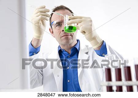 Scientist examining in lab View Large Photo Image Stock Photo - Scientist examining in lab . Fotosearch