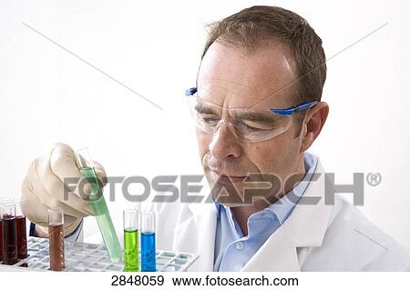 Stock Photo - Scientist examining with test tubes . Fotosearch