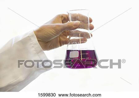 Stock Image - Scientist holding conical flask in laboratory . Fotosearch