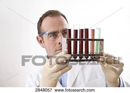 Stock Photo - Scientist holding test tube rack . Fotosearch