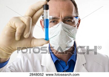Stock Image - Scientist holding test tube . Fotosearch