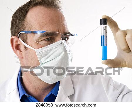 Stock Image - Scientist holding test tube . Fotosearch