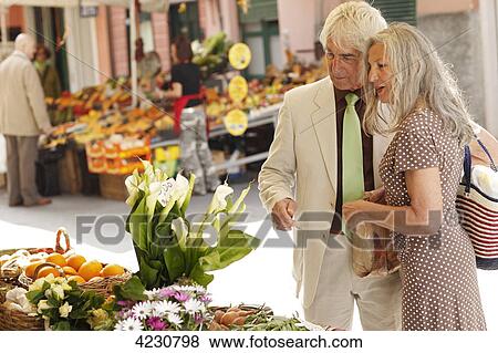 Stock Photo - Senior couple at a market stall, Italy, Rapallo . Fotosearch