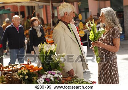 Senior couple at a market stall, Italy, Rapallo View Large Photo Image Stock Photo - Senior couple at a market stall, Italy, Rapallo . Fotosearch