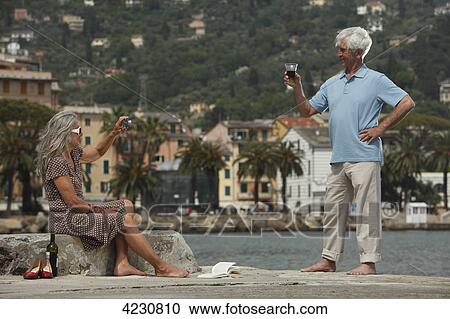 Senior couple drinking red wine by the water, Italy, Rapallo View Large Photo Image Stock Image - Senior couple drinking red wine by the water, Italy, Rapallo . Fotosearch