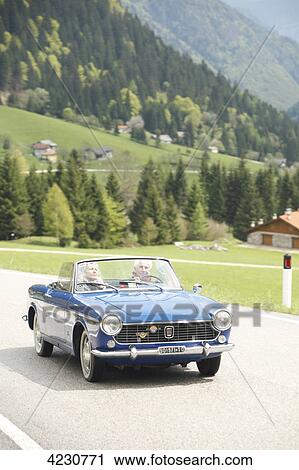 Senior couple driving convertible on country road, Italy, Telve View Large Photo Image Stock Image - Senior couple driving convertible on country road, Italy, Telve . Fotosearch