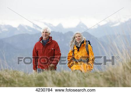 Senior couple hiking in mountain range, Italy, Monte Baldo View Large Photo Image Picture - Senior couple hiking in mountain range, Italy, Monte Baldo . Fotosearch