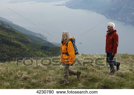 Senior couple hiking in mountain range, Italy, Monte Baldo View Large Photo Image Stock Image - Senior couple hiking in mountain range, Italy, Monte Baldo . Fotosearch
