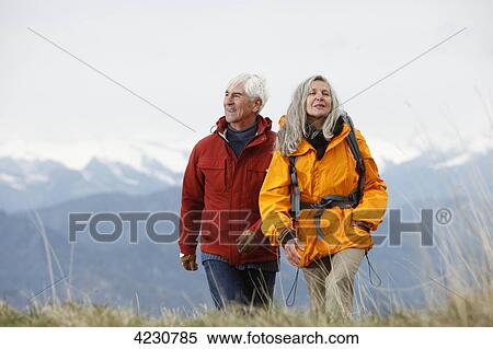 Stock Photography - Senior couple hiking in mountain range, Italy, Monte Baldo . Fotosearch