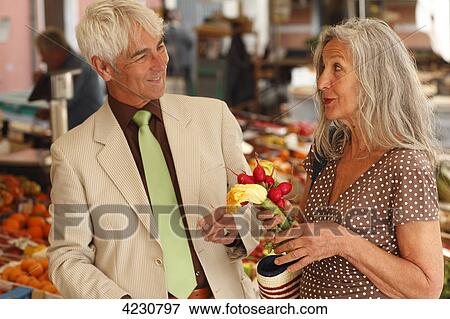 Senior couple on a vegetable market, Italy, Rapallo View Large Photo Image Stock Photo - Senior couple on a vegetable market, Italy, Rapallo . Fotosearch