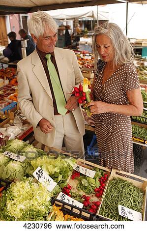 Stock Photograph - Senior couple on a vegetable market, Italy, Rapallo . Fotosearch