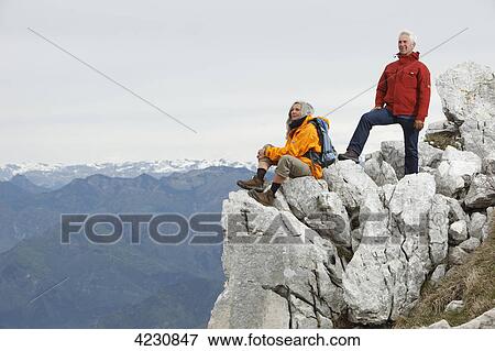 Senior couple on mountain peak, Italy, Monte Baldo, near Malcesine View Large Photo Image Stock Photo - Senior couple on mountain peak, Italy, Monte Baldo, near Malcesine . Fotosearch