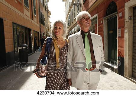 Senior couple strolling through town, Italy, Rapallo View Large Photo Image Picture - Senior couple strolling through town, Italy, Rapallo . Fotosearch