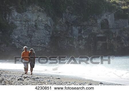 Senior couple walking on beach, Italy, Sori View Large Photo Image Stock Image - Senior couple walking on beach, Italy, Sori . Fotosearch