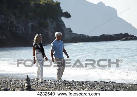 Senior couple walking on beach, Italy, Sori View Large Photo Image Stock Image - Senior couple walking on beach, Italy, Sori . Fotosearch