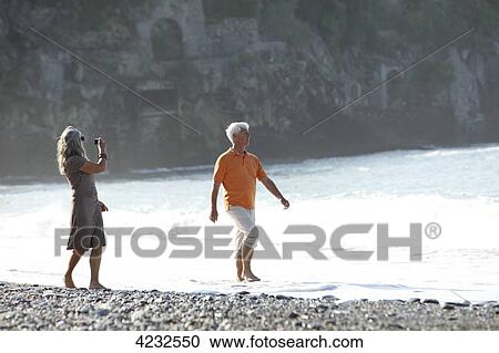 Senior couple walking on beach, Italy, Sori View Large Photo Image Stock Image - Senior couple walking on beach, Italy, Sori . Fotosearch