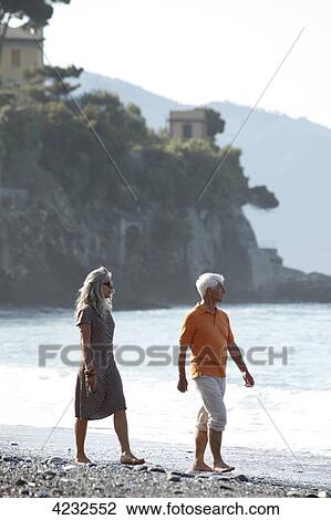 Senior couple walking on beach, Italy, Sori View Large Photo Image Stock Image - Senior couple walking on beach, Italy, Sori . Fotosearch