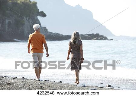 Senior couple walking on beach, Italy, Sori View Large Photo Image Stock Photo - Senior couple walking on beach, Italy, Sori . Fotosearch