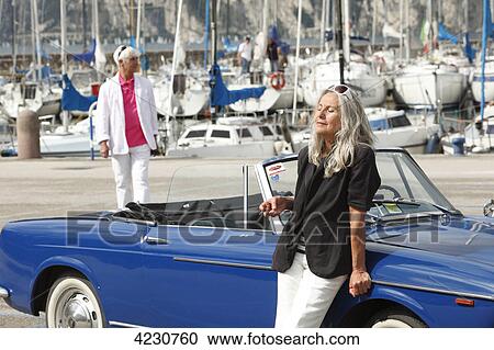 Senior couple with convertible at marina, Italy, Linfano View Large Photo Image Stock Image - Senior couple with convertible at marina, Italy, Linfano . Fotosearch