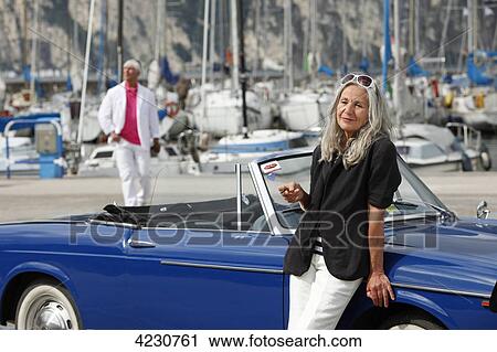 Senior couple with convertible at marina, Italy, Linfano View Large Photo Image Stock Image - Senior couple with convertible at marina, Italy, Linfano . Fotosearch