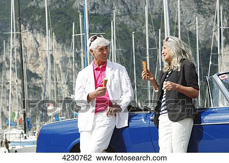 Senior couple with convertible at marina, Italy, Linfano View Large Photo Image Stock Image - Senior couple with convertible at marina, Italy, Linfano . Fotosearch