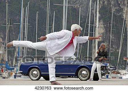 Senior couple with convertible at marina, Italy, Linfano View Large Photo Image Stock Image - Senior couple with convertible at marina, Italy, Linfano . Fotosearch
