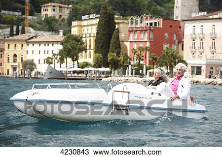 Senior couple with pedal boat on water, Italy, Riva del Garda, Lake Garda View Large Photo Image Stock Image - Senior couple with pedal boat on water, Italy, Riva del Garda, Lake Garda . Fotosearch