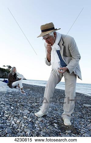 Senior man looking at stones on beach, Italy, Sori View Large Photo Image Stock Photography - Senior man looking at stones on beach, Italy, Sori . Fotosearch