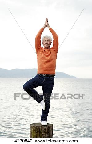 Senior man practicing yoga by the water, Italy, Gargnano, Lake Garda View Large Photo Image Stock Image - Senior man practicing yoga by the water, Italy, Gargnano, Lake Garda . Fotosearch