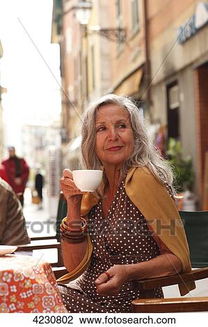 Senior woman at a sidewalk cafe, Italy, Rapallo View Large Photo Image Stock Image - Senior woman at a sidewalk cafe, Italy, Rapallo . Fotosearch
