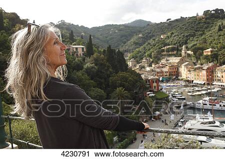 Senior woman looking at harbor and houses, Italy, Portofino  View Large Photo Image Stock Image - Senior woman looking at harbor and houses, Italy, Portofino . Fotosearch