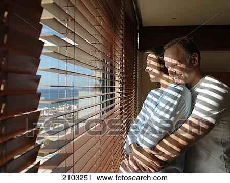 Side profile of couple romancing near window View Large Photo Image Stock Image - Side profile of couple romancing near window . Fotosearch