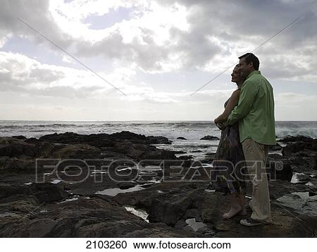 Side profile of couple standing at poolside View Large Photo Image Stock Image - Side profile of couple standing at poolside . Fotosearch