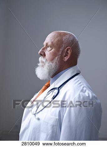 Stock Photo - Side profile of male doctor thinking . Fotosearch