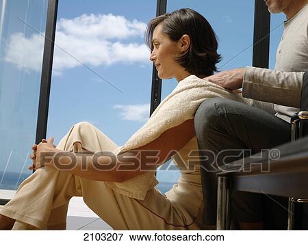 Side profile of man massaging her wife's shoulders View Large Photo Image Stock Photo - Side profile of man massaging her wife's shoulders . Fotosearch