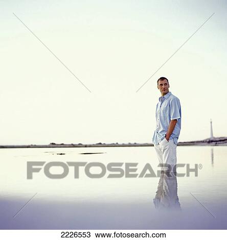 Side profile of man standing in water View Large Photo Image Stock Image - Side profile of man standing in water . Fotosearch