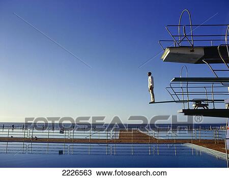 Side profile of man standing on diving board View Large Photo Image Stock Image - Side profile of man standing on diving board . Fotosearch