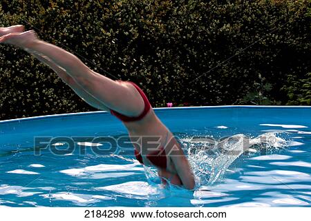 Stock Photo - Side profile of woman diving in pool . Fotosearch