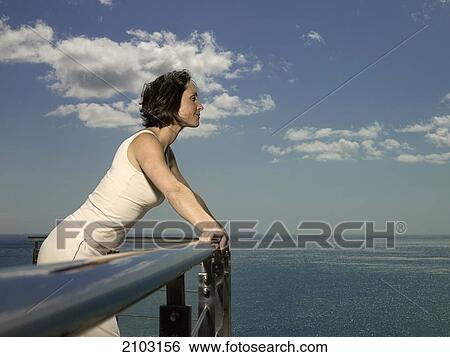 Side profile of woman leaning on railing View Large Photo Image Stock Photograph - Side profile of woman leaning on railing . Fotosearch