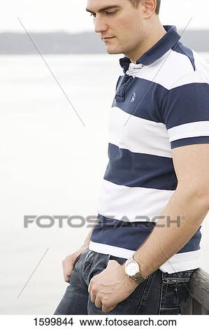 Side profile of young man thinking View Large Photo Image Picture - Side profile of young man thinking . Fotosearch