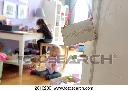 Signboard at door of room with two girls studying in background View Large Photo Image Stock Image - Signboard at door of room with two girls studying in background . Fotosearch