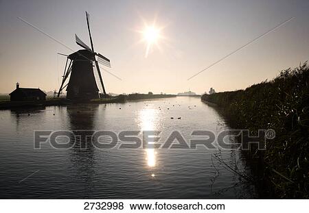 Silhouette of traditional windmill at waterfront View Large Photo Image Stock Photo - Silhouette of traditional windmill at waterfront . Fotosearch
