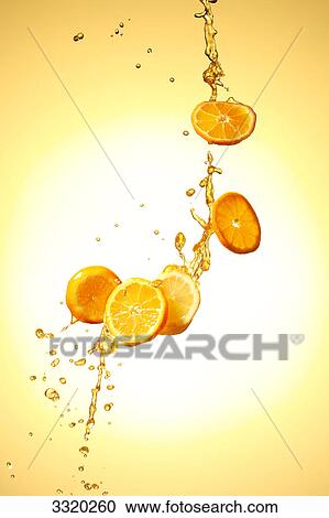 Stock Image - Slices of oranges in the air . Fotosearch