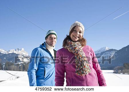 Smiling couple in winter landscape, Tannheimer Tal, Tyrol, Austria View Large Photo Image Stock Image - Smiling couple in winter landscape, Tannheimer Tal, Tyrol, Austria . Fotosearch